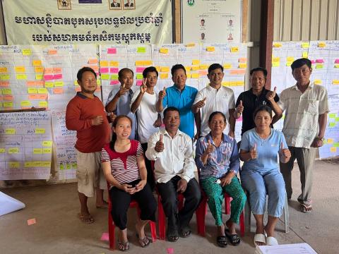 Group of people in Cambodia in front of boards filled with post-its